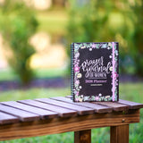 Planner titled 'Prayers & Journal for Women 2026 Planner' on a wooden table with a blurred natural background