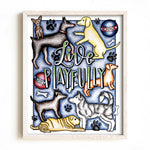 Framed artwork with cartoon dogs and the text 'Live Playfully' on a blue background.