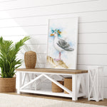 Decorative scene with a seagull painting on a wall above a wooden table.