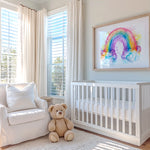 A nursery featuring a rainbow watercolor wall art print